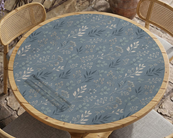 Blue mahjong mat with a botanical floral pattern, pale leaves, and delicate stems on a dusty blue background.