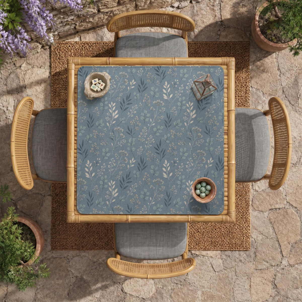 Blue mahjong mat with a dusty linen-look background and small leafy botanical stems in a floral pattern.