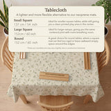 Sage green botanical mahjong mat with a cream background, trailing vines, and muted leaf designs.