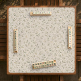 Sage green mahjong mat with vine and botanical artwork in cream neutral tones, shown in a cottagecore style with a tablecloth-style format.