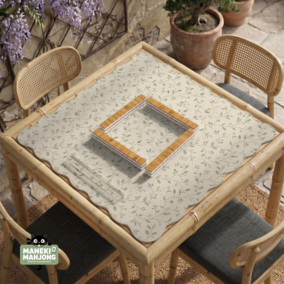Sage green botanical mahjong mat with a cream background, trailing vines, and muted leaf designs.
