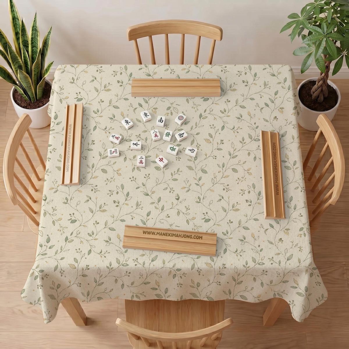 Sage green botanical mahjong mat with a cream background, trailing vines, and muted leaf designs.