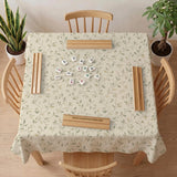 Sage green botanical mahjong mat with a cream background, trailing vines, and muted leaf designs.