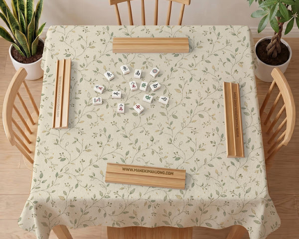 Sage green mahjong mat with vine and botanical artwork in cream neutral tones, shown in a cottagecore style with a tablecloth-style format.