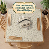 Sage green mahjong mat with vine and botanical artwork in cream neutral tones, shown in a cottagecore style with a tablecloth-style format.