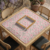 Pink mahjong mat with a tulip floral pattern in blush and sage tones and a scalloped edge.
