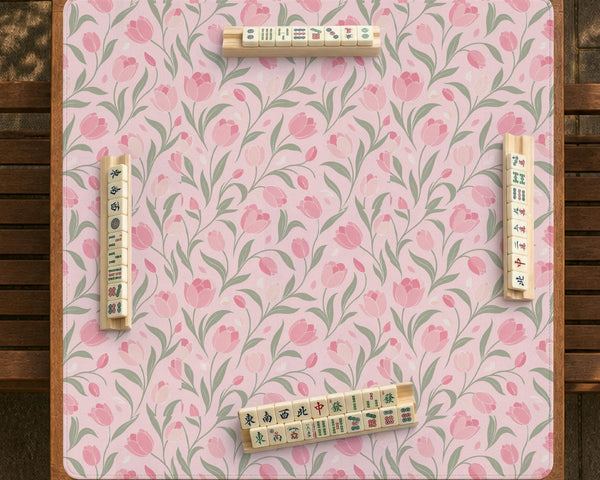 Pink mahjong mat with a tulip floral pattern in blush and sage tones and a scalloped edge.