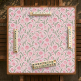 Pink mahjong mat with a botanical tulip floral pattern in blush tones, shown in a tablecloth-style square layout.