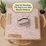 Pink mahjong mat with a tulip floral pattern in blush and sage tones and a scalloped edge.