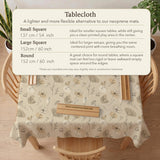 Neutral floral mahjong mat with delicate botanical line art and a scalloped edge on a cream background.