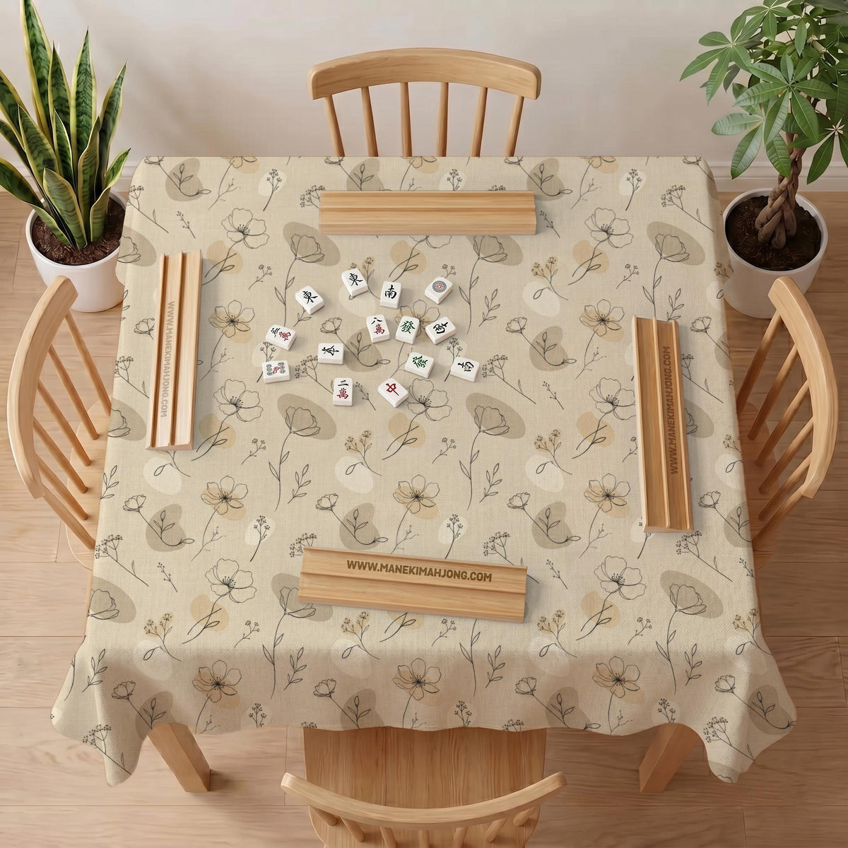 Neutral floral mahjong mat with delicate botanical line art and a scalloped edge on a cream background.