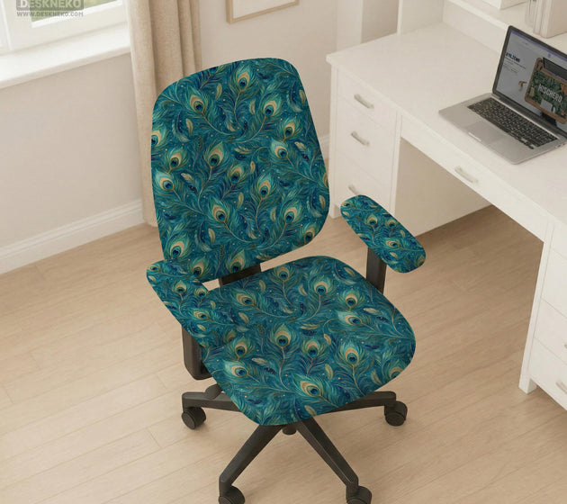 A blue green chair cover with a peacock feather design shown on an office chair with armrests.