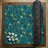 A teal mahjong mat with a peacock feather pattern and scalloped edges.