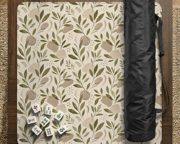 Green botanical mahjong mat with sage leaf and floral design and a scalloped edge.