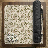 Green botanical mahjong mat with sage leaf and floral design and a scalloped edge.