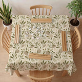 Green botanical mahjong mat with sage leaf and floral design and a scalloped edge.