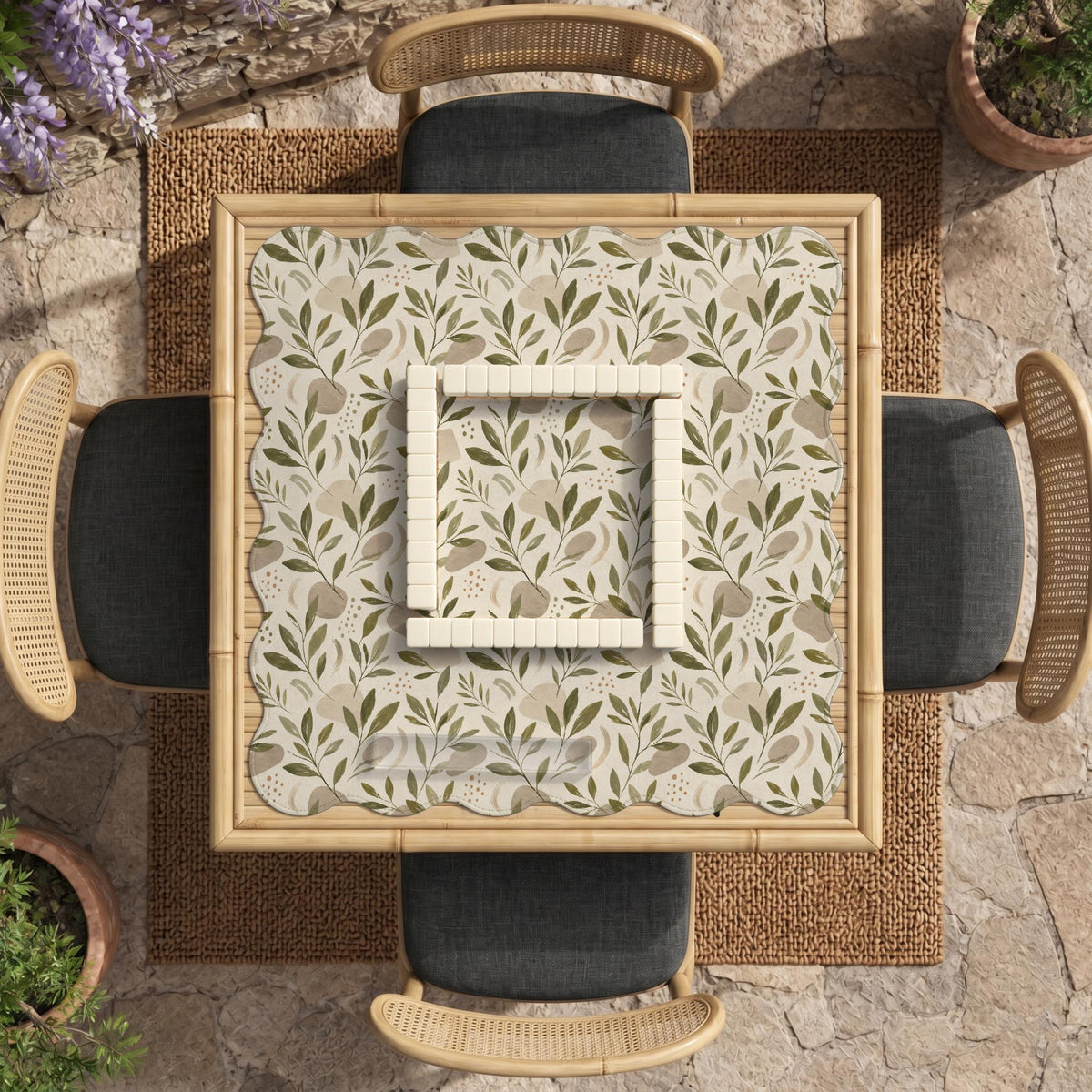 Green botanical mahjong mat with sage leaf and floral design and a scalloped edge.