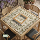 Green botanical mahjong mat with sage leaf and floral design and a scalloped edge.