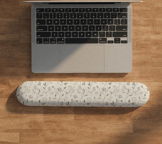 Ivory mouse pad and keyboard wrist rest with delicate wildflower line art in sage, taupe, and cream tones.