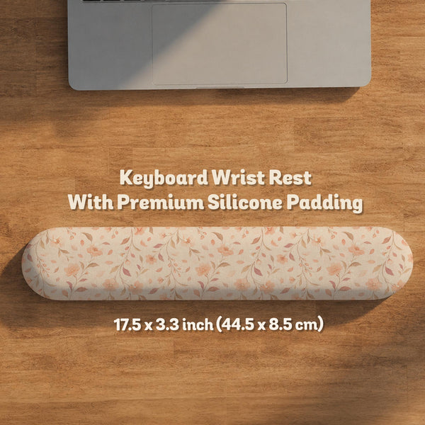 Blush pink floral mouse pad with wrist rest options, shown with peach blossoms, muted leaves, and a warm cream background.