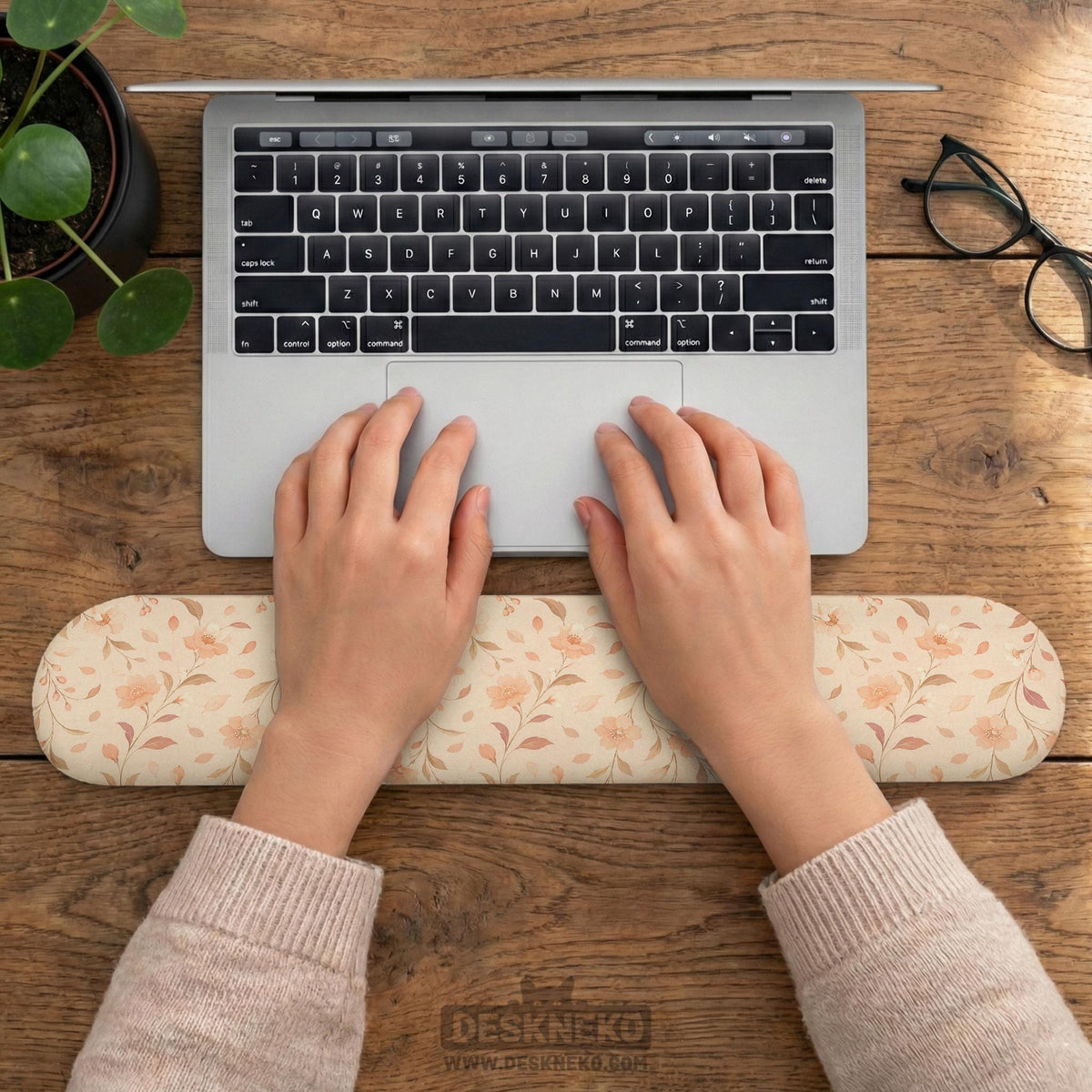 Blush pink floral mouse pad with wrist rest options, shown with peach blossoms, muted leaves, and a warm cream background.