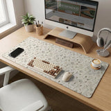 Ivory desk mat with delicate sage and taupe vine and floral artwork on a neutral background.
