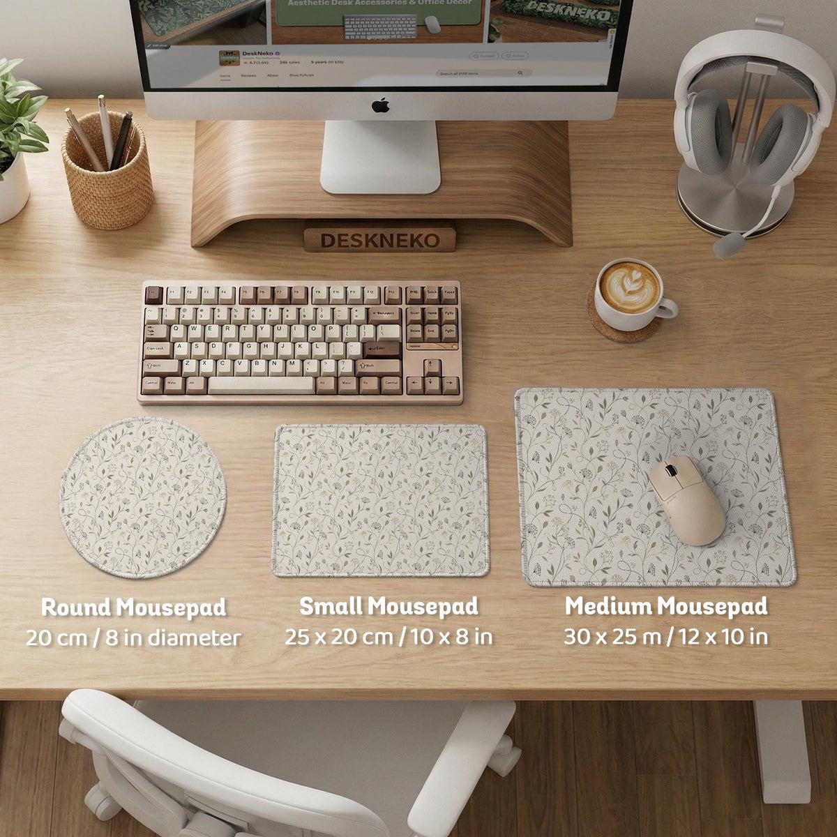 Ivory desk mat with delicate sage and taupe vine and floral artwork on a neutral background.