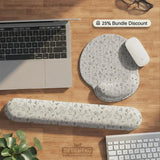 Ivory desk mat with delicate sage and taupe vine and floral artwork on a neutral background.