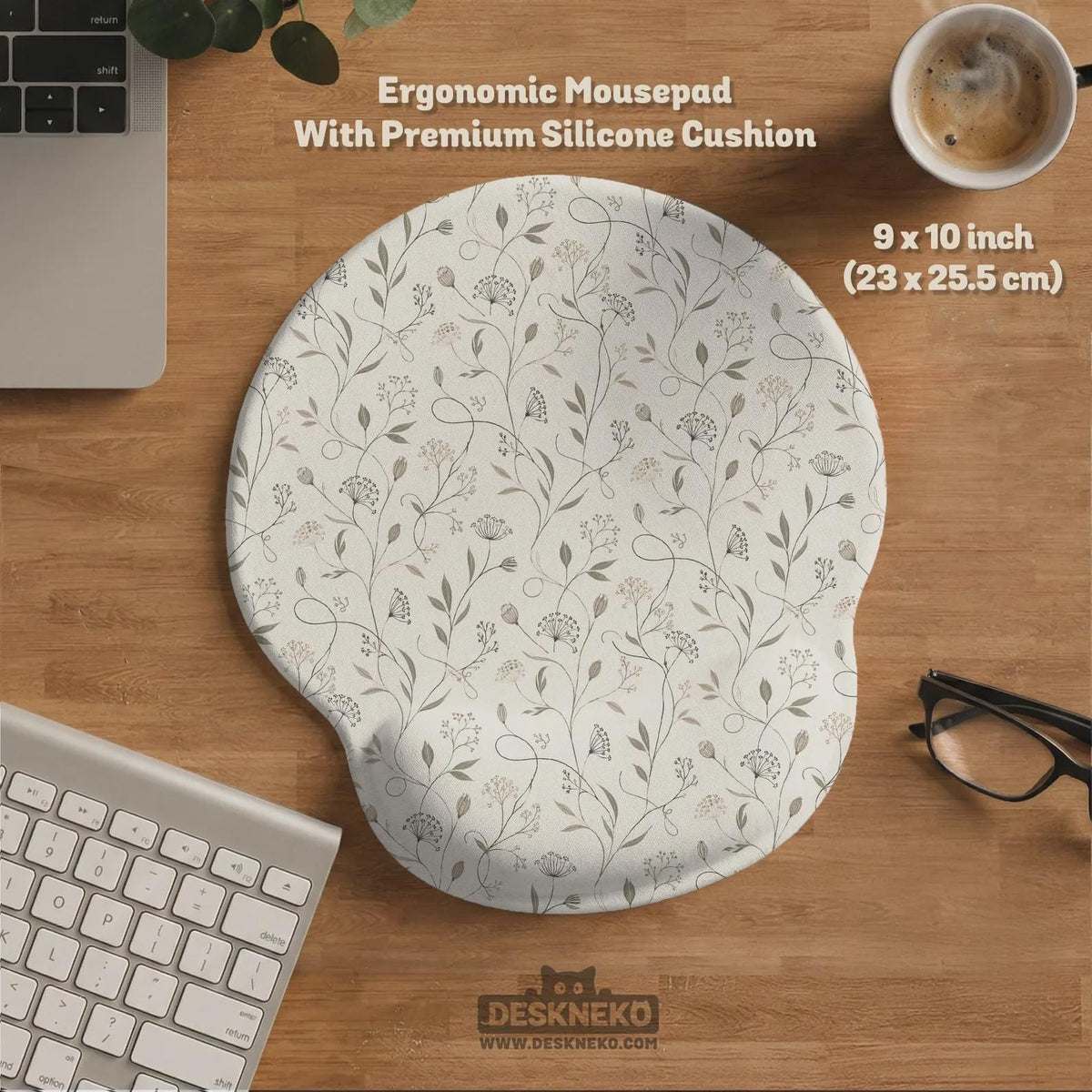 Ivory desk mat with delicate sage and taupe vine and floral artwork on a neutral background.