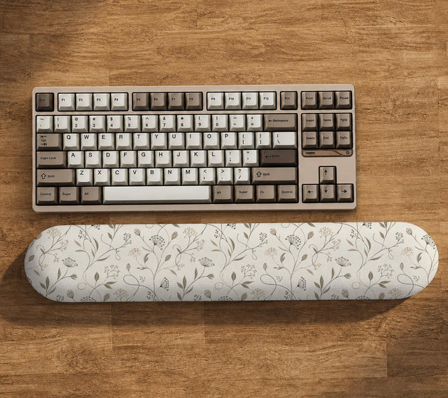 Ivory mouse pad and keyboard wrist rest with delicate wildflower line art in sage, taupe, and cream tones.