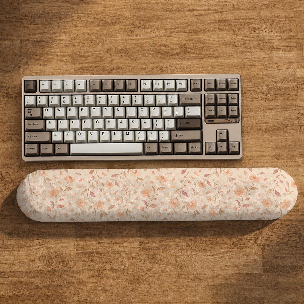 Blush pink floral mouse pad with wrist rest options, shown with peach blossoms, muted leaves, and a warm cream background.