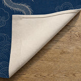 Folded corner of the indigo dragon noren showing the printed front face and plain off-white reverse.