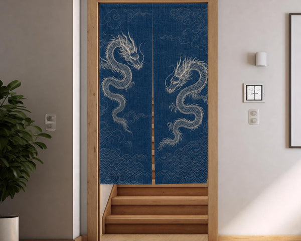 Indigo dragon noren hanging in a doorway at the top of wooden stairs, panels parting slightly at the bottom.