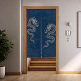 Indigo dragon noren hanging in a doorway at the top of wooden stairs, panels parting slightly at the bottom.