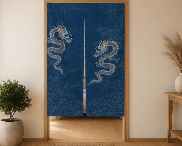 Straight-on view of the two-panel indigo dragon noren in a wooden doorway with a woven rug below.