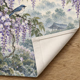 A noren curtain with wisteria blossoms, lilac flowers, blue songbirds, leafy branches, gentle rain, and a misty garden background.