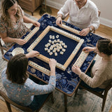 Navy mahjong mat with cranes, garden birds, pagodas, and blue and cream floral designs around a framed playing area with a printed Charleston guide.