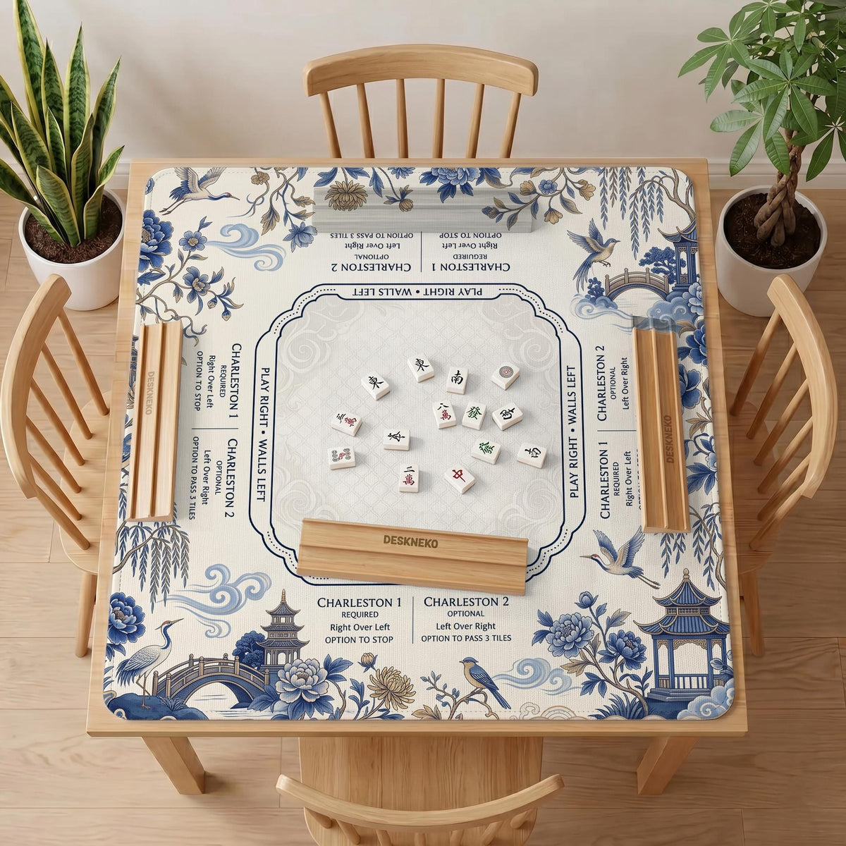 Square ivory mahjong mat with blue cranes, pagodas, flowers, and a blue border around the playing area.