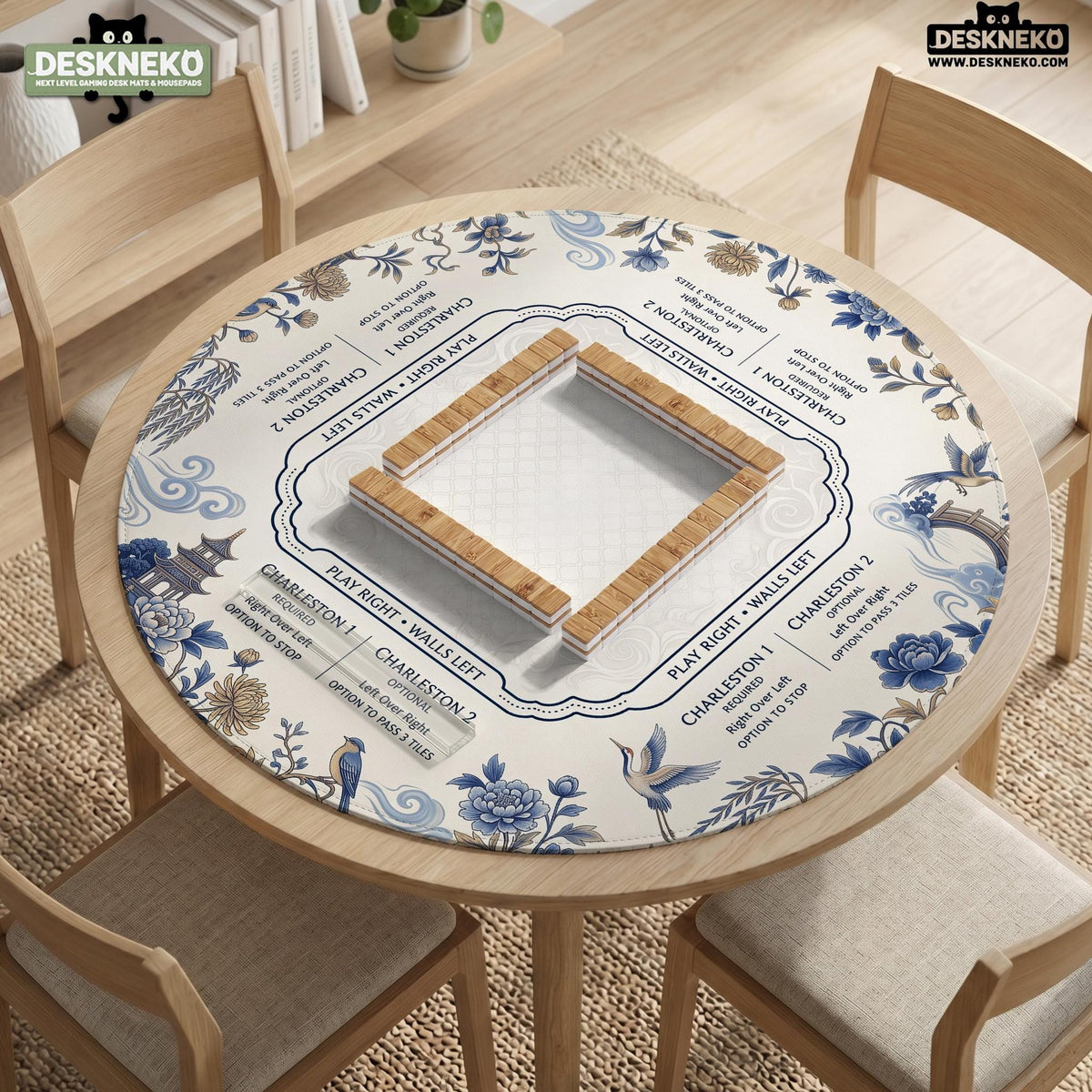Square ivory mahjong mat with blue cranes, pagodas, flowers, and a blue border around the playing area.