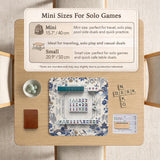 Square ivory mahjong mat with blue cranes, pagodas, flowers, and a blue border around the playing area.