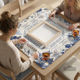 Square ivory mahjong mat with blue cranes, pagodas, flowers, and a blue border around the playing area.