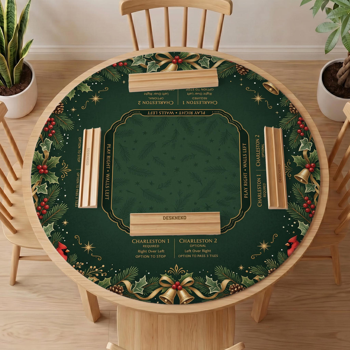 Green mahjong mat with red cardinals, holly berries, cream poinsettias, and gold seasonal details around a printed Charleston guide.