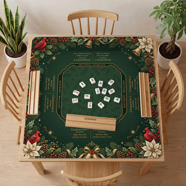 Green mahjong mat with red cardinals, holly berries, cream poinsettias, and gold seasonal details around a printed Charleston guide.