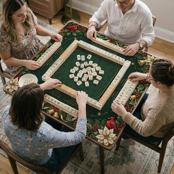 Green mahjong mat with red cardinals, holly berries, cream poinsettias, and gold seasonal details around a printed Charleston guide.