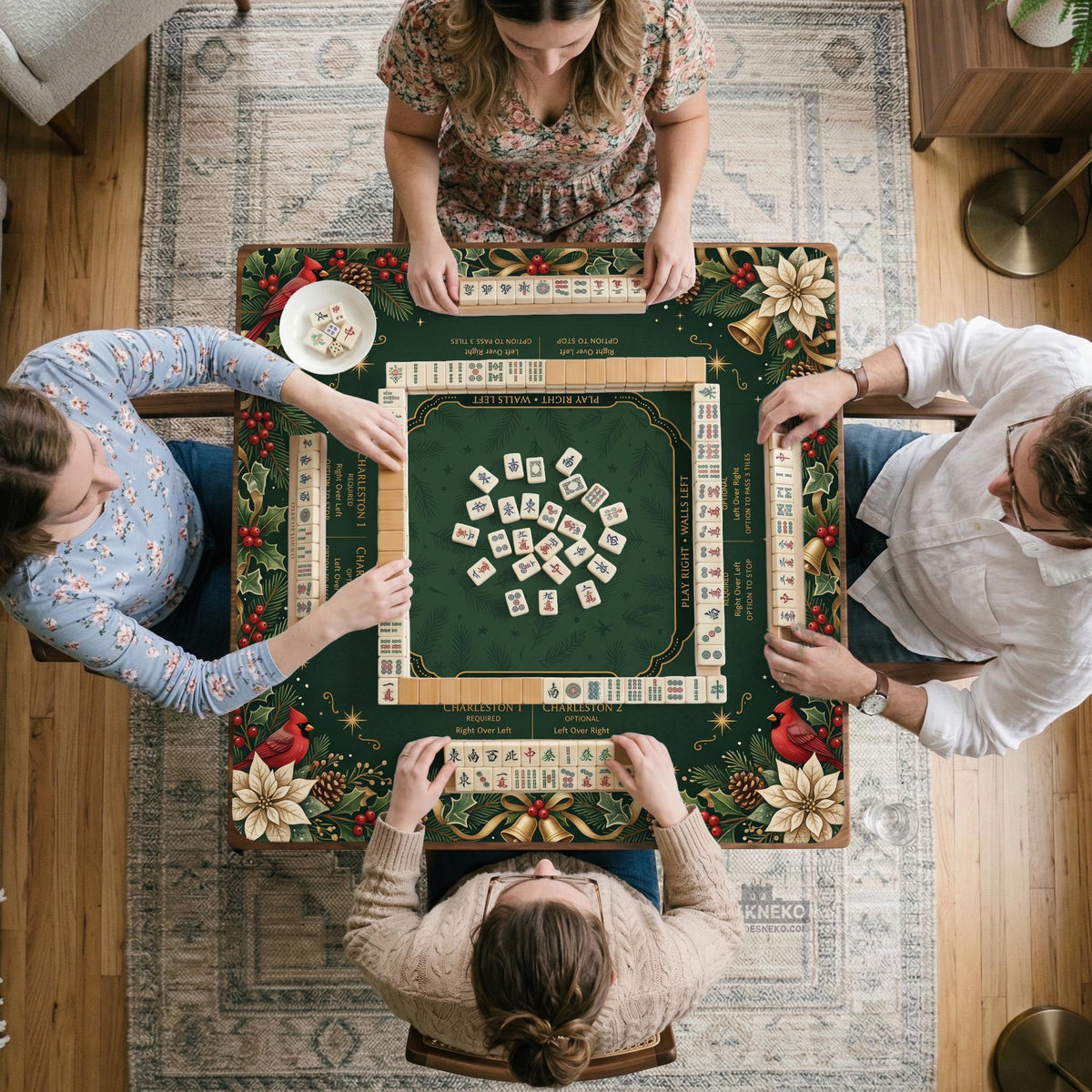 Green mahjong mat with red cardinals, holly berries, cream poinsettias, and gold seasonal details around a printed Charleston guide.