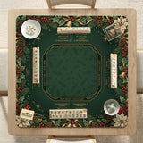 Green mahjong mat with red cardinals, holly berries, cream poinsettias, and gold seasonal details around a printed Charleston guide.