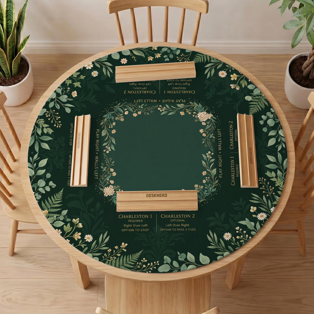 Square mahjong mat with a forest green botanical design, fern leaves, small cream flowers, and a printed Charleston guide around the center area.