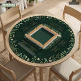 Square mahjong mat with a forest green botanical design, fern leaves, small cream flowers, and a printed Charleston guide around the center area.