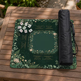 Square mahjong mat with a forest green botanical design, fern leaves, small cream flowers, and a printed Charleston guide around the center area.