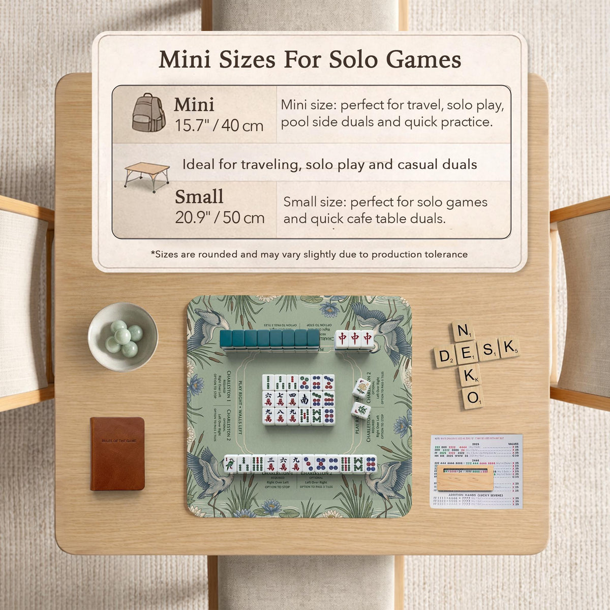 American mahjong mat with a sage-green pond scene, blue-grey herons, water lilies, reeds, and printed play-direction reminders around the edge.